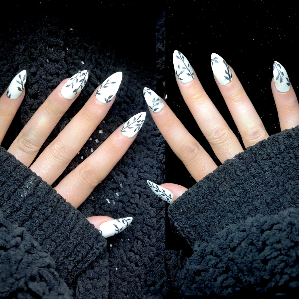 white press on nail enhancements with black vine plants nail art design