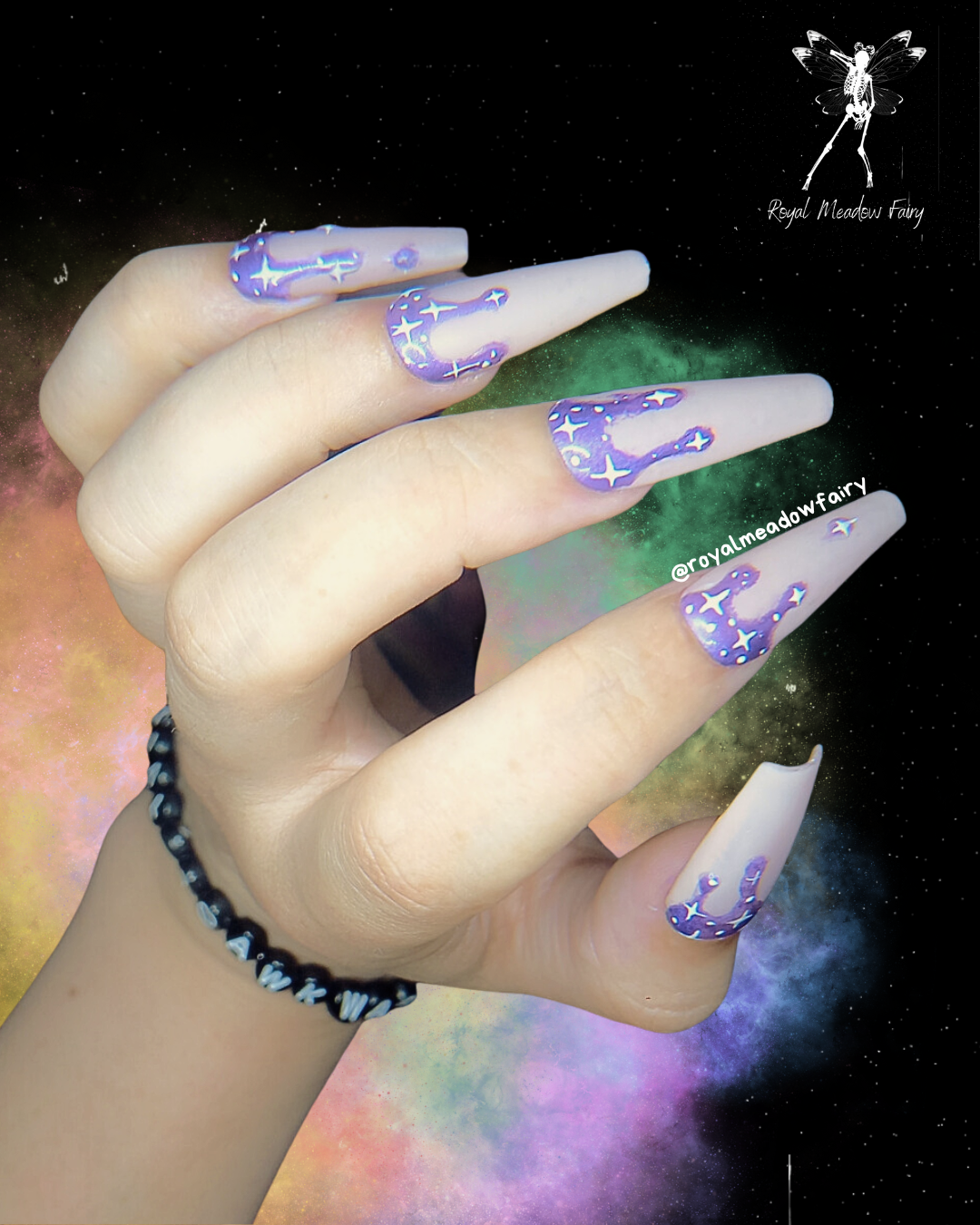 shiny purple drip stick on nail enhancements with white celestial star nail art