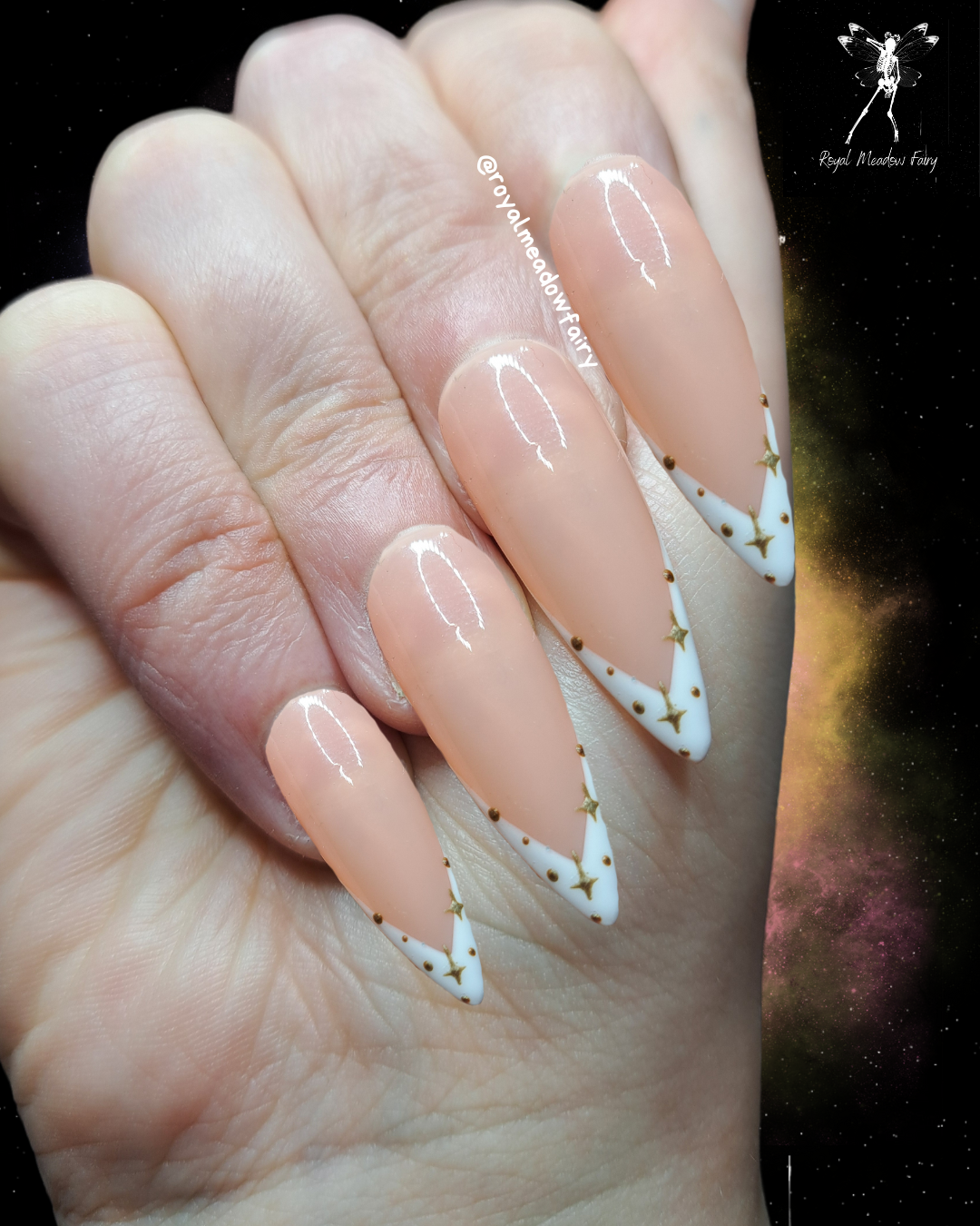 nude and wite french tip press on nails with goldf nail art design of dots and stars 