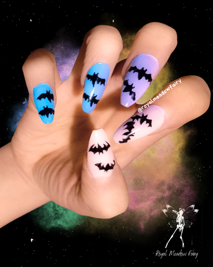 blue to purple and pink ombre stick-on fake nails with black bats nail art pastel goth design 