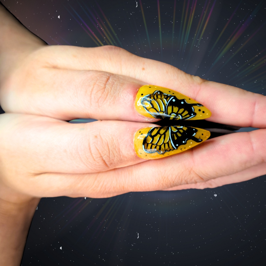 yellow glue on false nail extensions with tattoo style butterfly nail art 