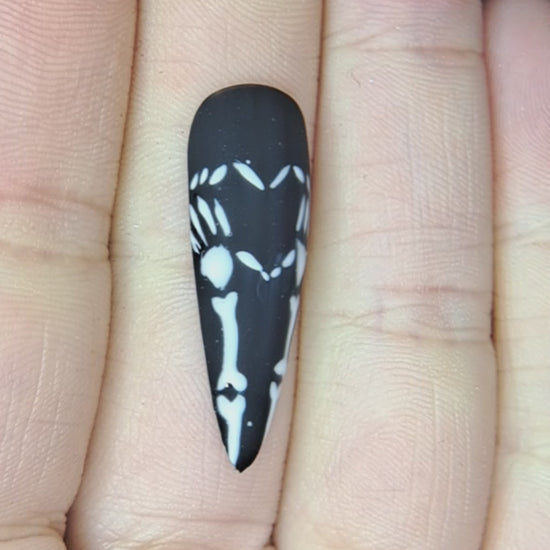 black press on nails with valentines nail art design of skeleton hands forming a heart 