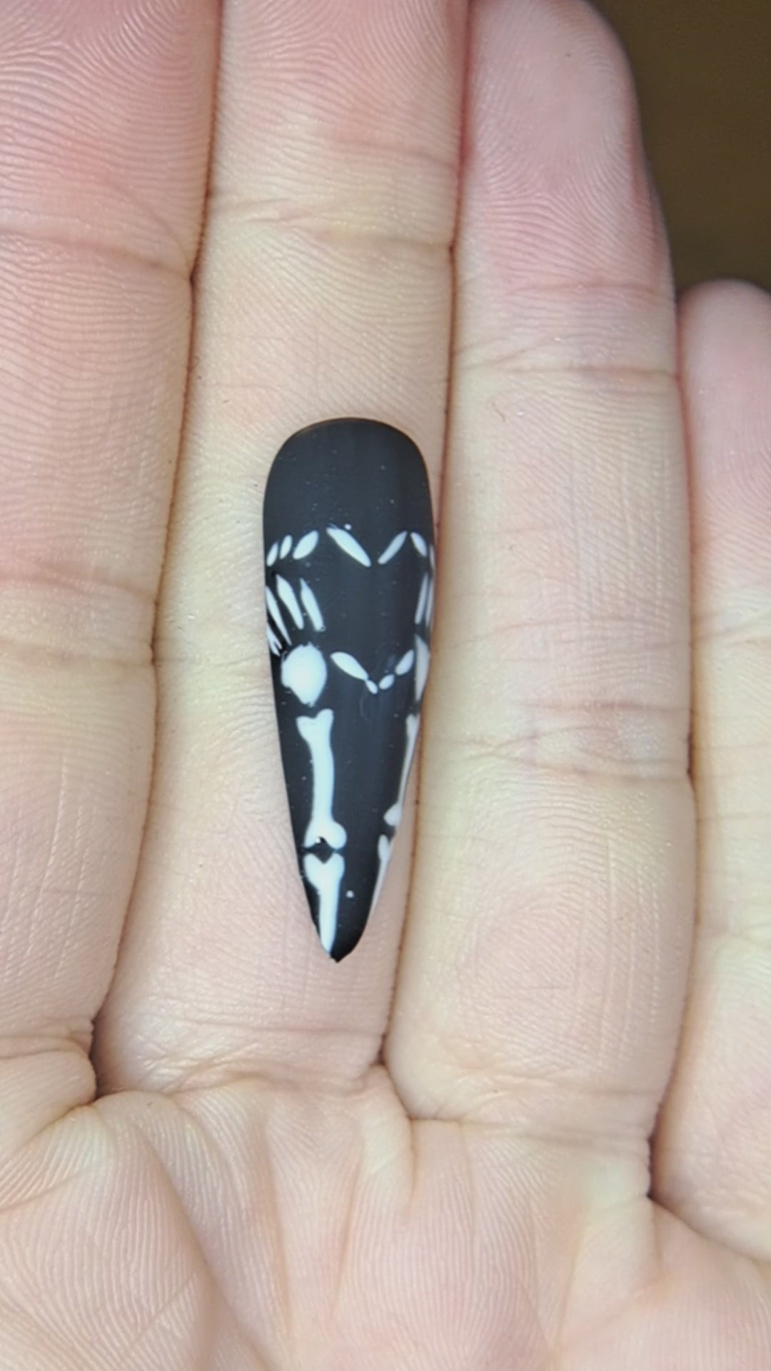 black press on nails with valentines nail art design of skeleton hands forming a heart 