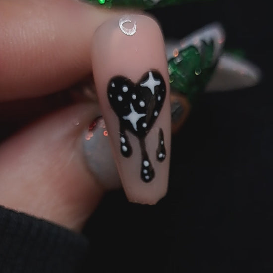 nude press on nails with valentines nail art design of a dripping black heart and stars 