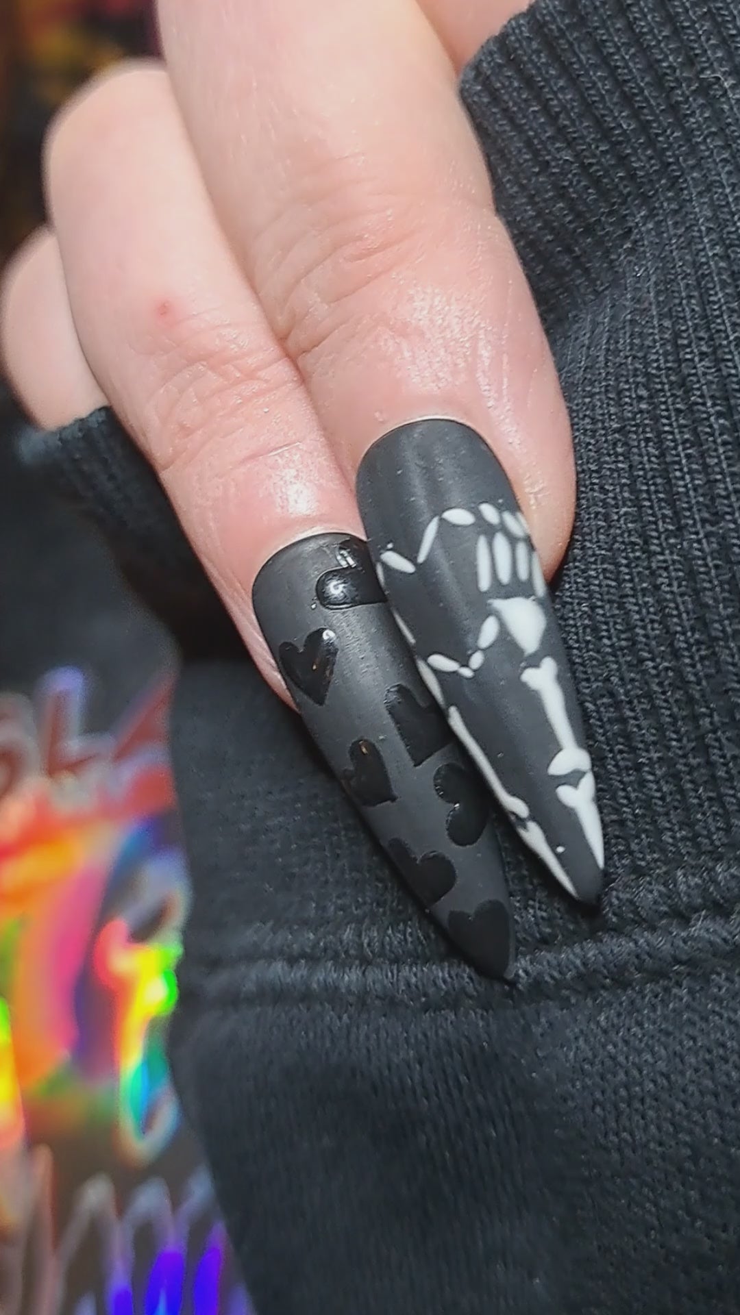 black gothic press on nails with alt black hearts and emo skeleton hands forming a heart nail art 