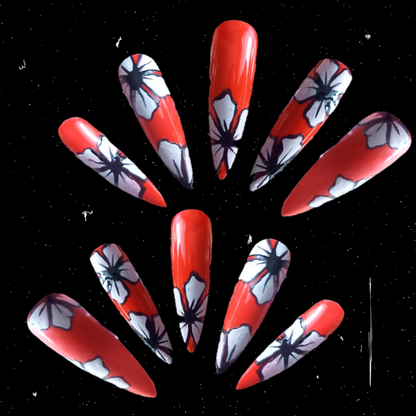 scarlet red stick-on nail enhancements with Hawaiian tattoo style white flowers floral nail art design  